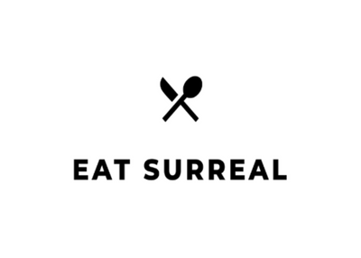 A minimalist black logo featuring a crossed spoon and knife icon above the text 'EAT SURREAL' on a solid white background.